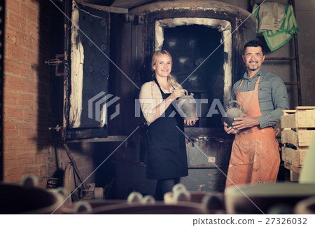 potters holding black ceramic vases potters holding black ceramic vases 27326032