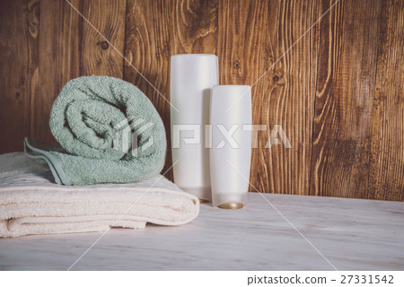 Stacked towels on wooden background Stacked towels on wooden background 27331542