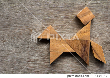 Wooden tangram as man ride the horse shape 27334187