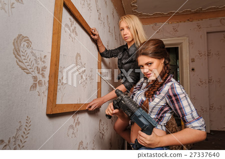 Attractive women with puncher and frame 27337640