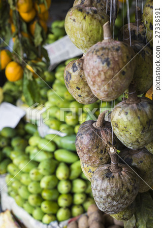 A lot of tropical fruits in outdoor market 27338591