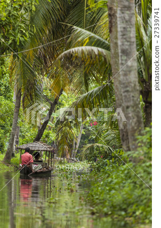 Unidentified indian people in small boat in backwa 27339741
