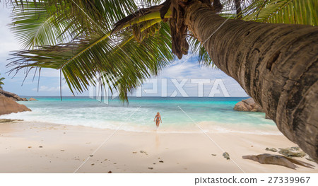 Woman enjoying Anse Patates picture perfect beach 27339967