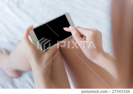 woman typing on smartphone woman typing on smartphone 27343189