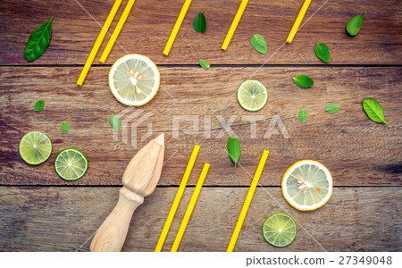 Fresh lemon and wooden juicer . 27349048