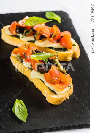 Bruschetta with tomato, mozarella and basil 27349347