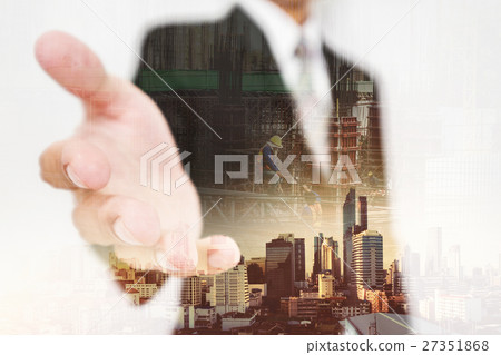 Businessman stretch hand,with buildings background Businessman stretch hand,with buildings background 27351868