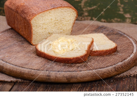 Sliced white bread on wooden board table 27352145