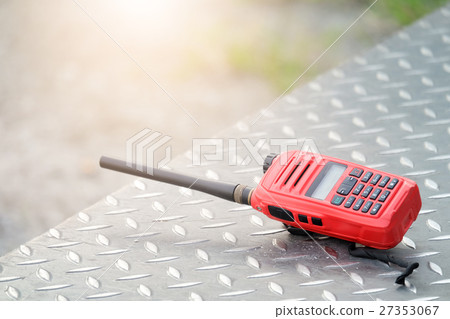 Walkie Talkie communication rests on a steel floor 27353067