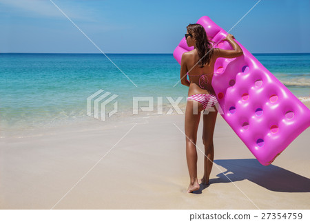 slim brunette woman sunbathe with an air mattress slim brunette woman sunbathe with an air mattress 27354759