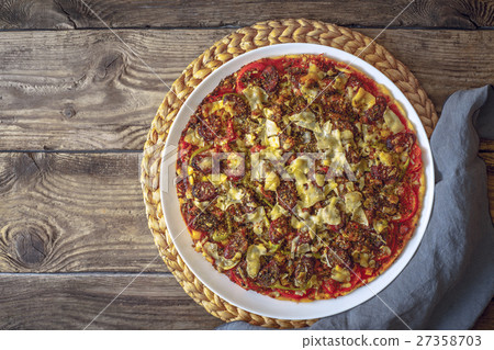 Preparing a pizza on a wooden table 27358703