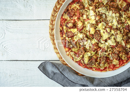 Preparing a pizza on a white table Preparing a pizza on a white table 27358704