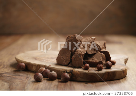 chunks of gianduja with hazelnuts on wood board chunks of gianduja with hazelnuts on wood board 27358706