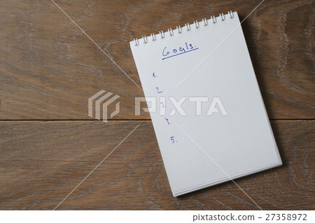 blank notepad on wooden table with word goals blank notepad on wooden table with word goals 27358972
