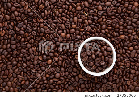 white cup of roasted coffee bean on top of flat la 27359069