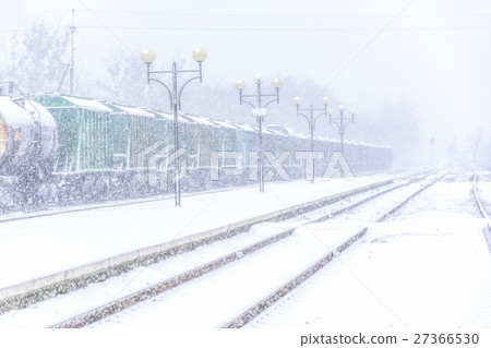 Blizzard on railway, freight train in snow 27366530