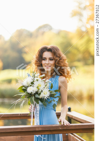 Beautiful young bridesmaid with long curly hair 27367812