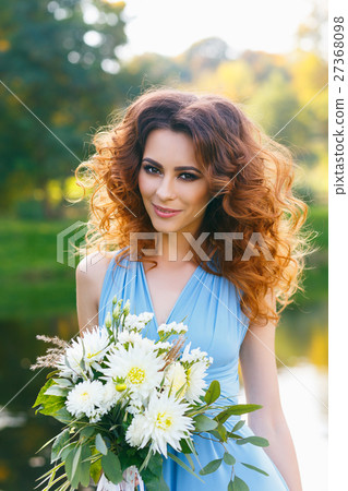 Beautiful young woman with long curly hair Beautiful young woman with long curly hair 27368098