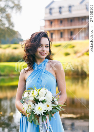 Beautiful young woman with curly hair 27368102