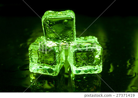 Wet ice cubes on black background with green light 27371419