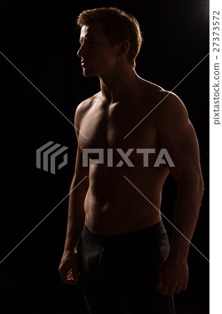 Male fitness model showing muscles in studio Male fitness model showing muscles in studio 27373572