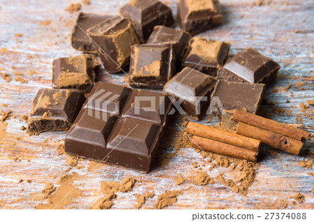 Chocolate on cocoa sprinkled table and cinnamon 27374088