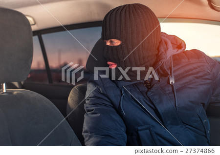 Male car thief in robbery mask stealing auto Male car thief in robbery mask stealing auto 27374866