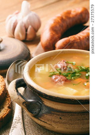 Pea soup with smoked sausage. 27375579