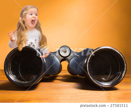 Happy little girl and binoculars over orange Happy little girl and binoculars over orange 27381511