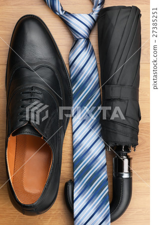Classic men's shoes, tie, umbrella on the floor Classic men's shoes, tie, umbrella on the floor 27385251