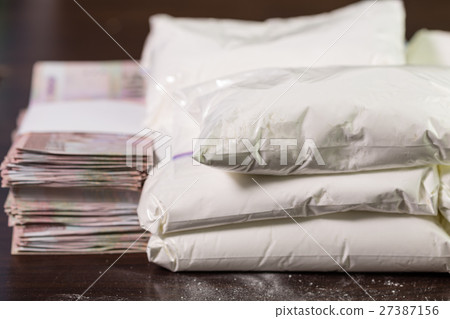 Bags of drugs, and money on table 27387156
