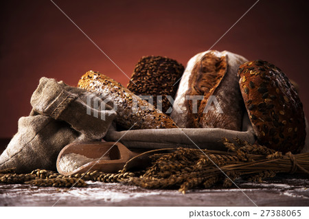 Fresh bread and wheat on the wooden table Fresh bread and wheat on the wooden table 27388065
