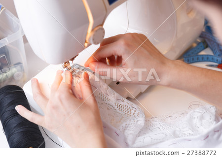 Woman doing lines on sewing-machine Woman doing lines on sewing-machine 27388772