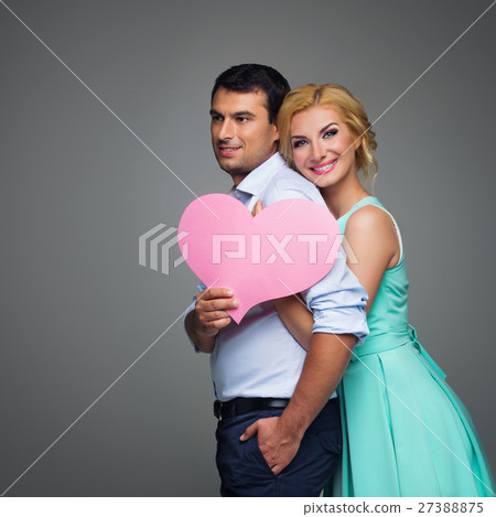 Beautiful couple holding pink heart 27388875