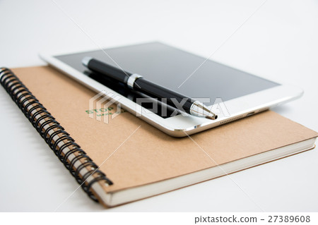 Put a pen on tablet and notebook. Put a pen on tablet and notebook. 27389608