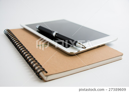Put a pen on tablet and notebook. Put a pen on tablet and notebook. 27389609