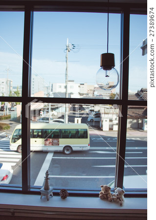 Hanging Light Bulb near glass window 27389674