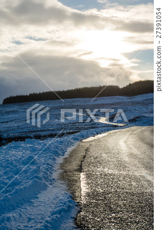 One trail in one hill of snow and the forest and sunshine visible in the distant Scottish suburbs One trail in one hill of snow and the forest and sunshine visible in the distant Scottish suburbs 27391054
