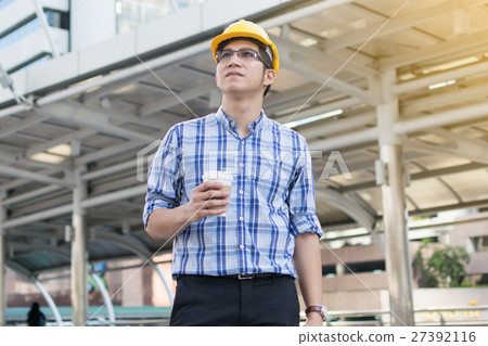 Foreman construction worker holding blueprint 27392116