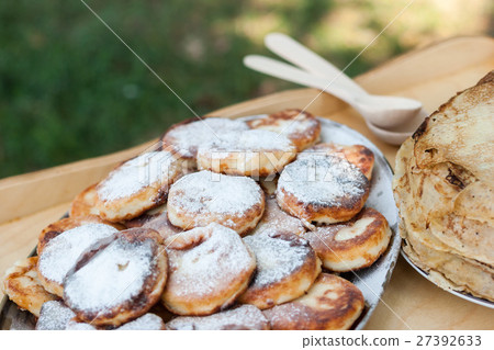 cheesecake and pancakes on the wooden table. cheesecake and pancakes on the wooden table. 27392633