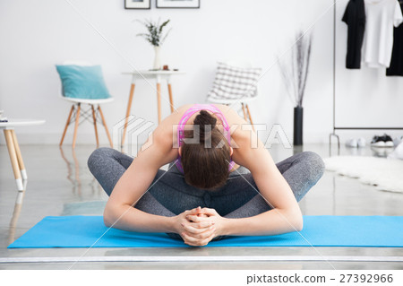 Young Caucasian woman stretching yoga at home 27392966