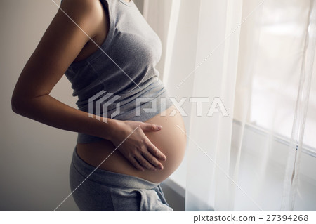 young pregnant girl in a gray t-shirt and pants 27394268