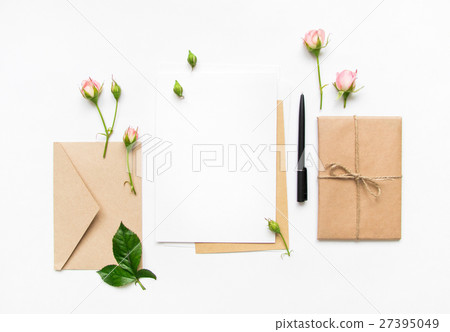 Letter envelope and gift with pink roses. Flat lay Letter envelope and gift with pink roses. Flat lay 27395049