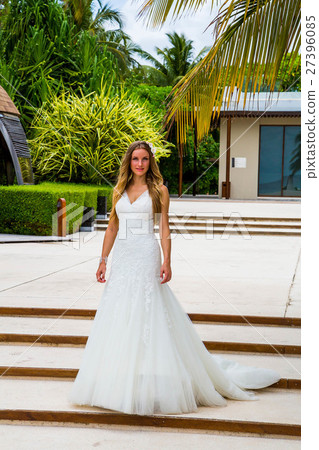 Beautiful bride walking alone in a tropical island 27396085