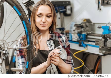 Smiling young craftswoman relaxing in the garage 27396233