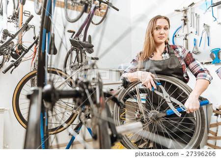 Delighted young craftswoman working in the repair 27396266