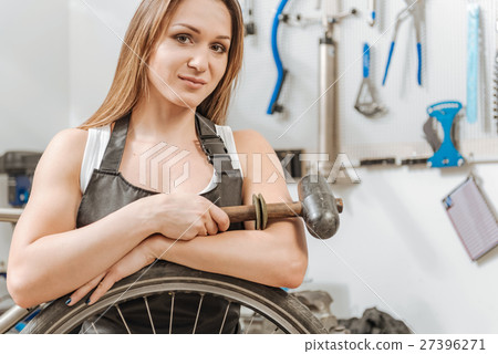 Pleasant craftswoman standing in the workshop 27396271