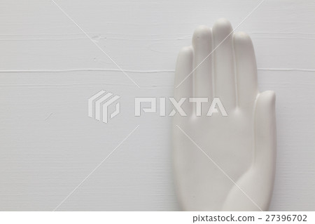 Detail of artifical hand on the wooden table Detail of artifical hand on the wooden table 27396702