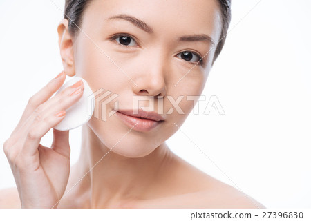 Pretty cheerful woman cleaning her face Pretty cheerful woman cleaning her face 27396830
