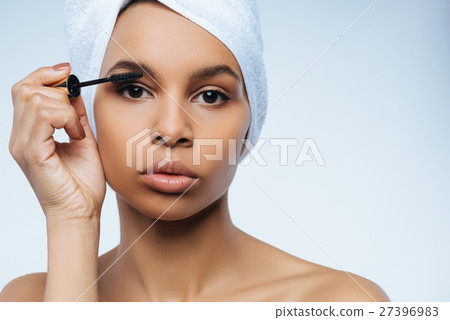 Pleasant cute woman using mascara Pleasant cute woman using mascara 27396983